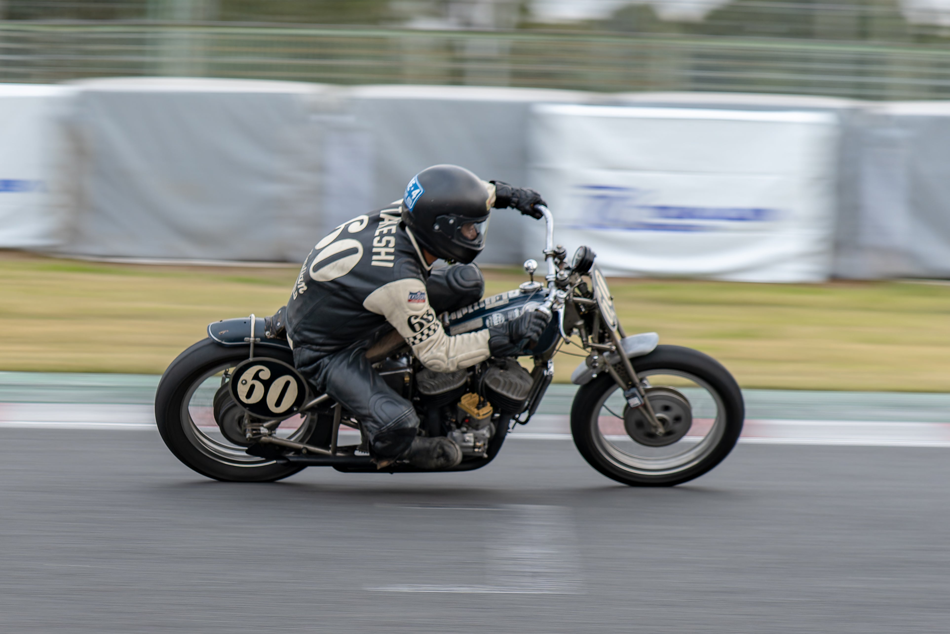 Racing around the circuit, on a vintage bike.