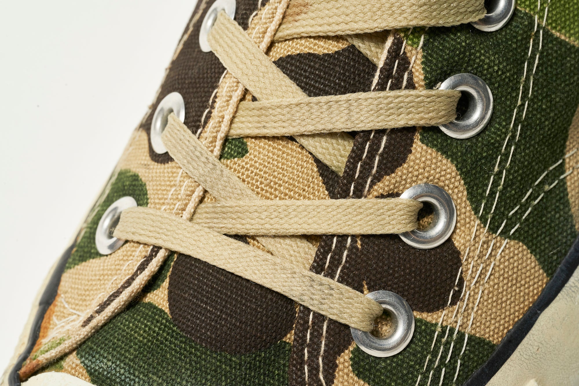 The 83 Camo was released as the first patterned All Star. It comes with beige shoelaces that match the pattern.