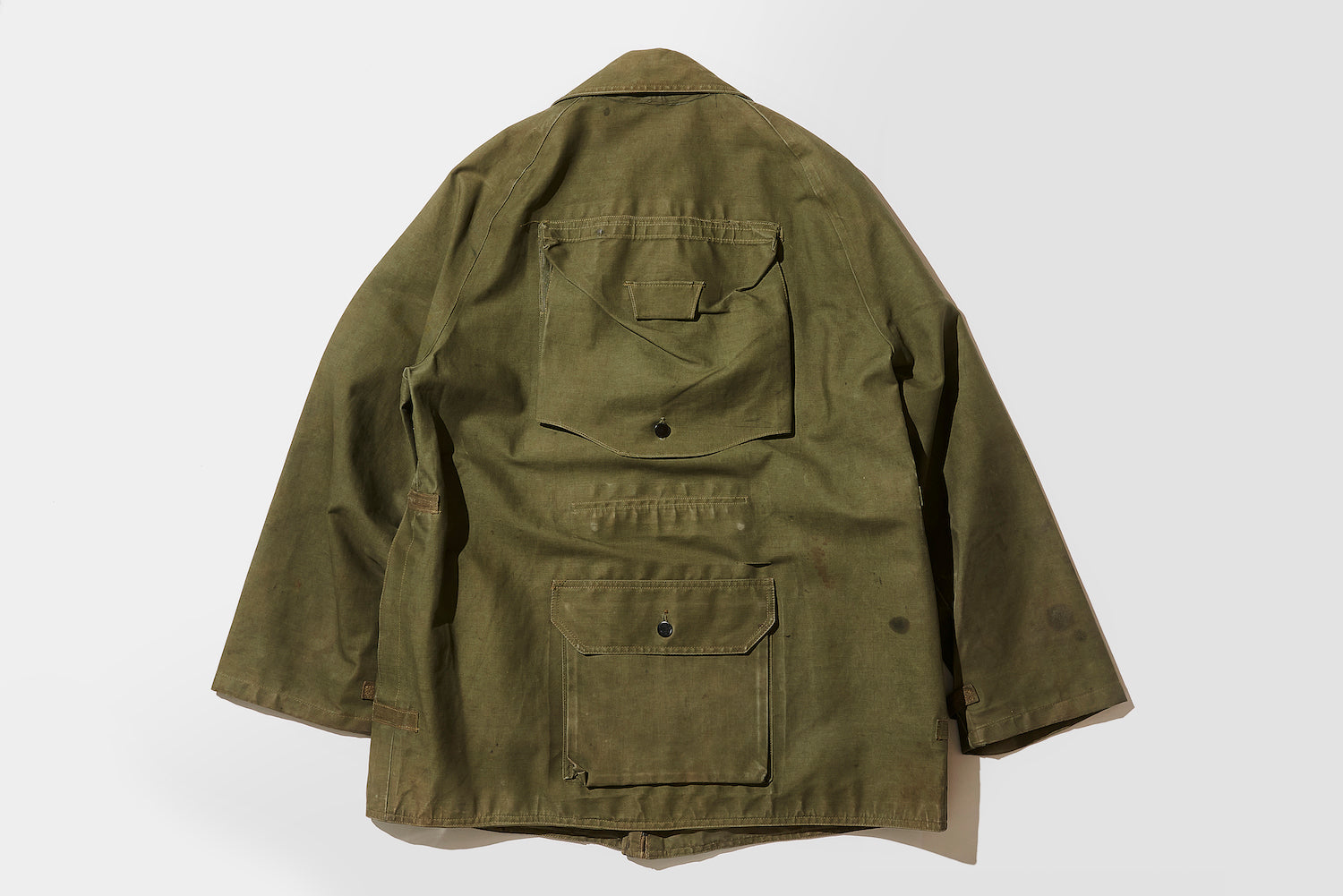 The back view highlights the unique details, such as pockets on the back and waist.