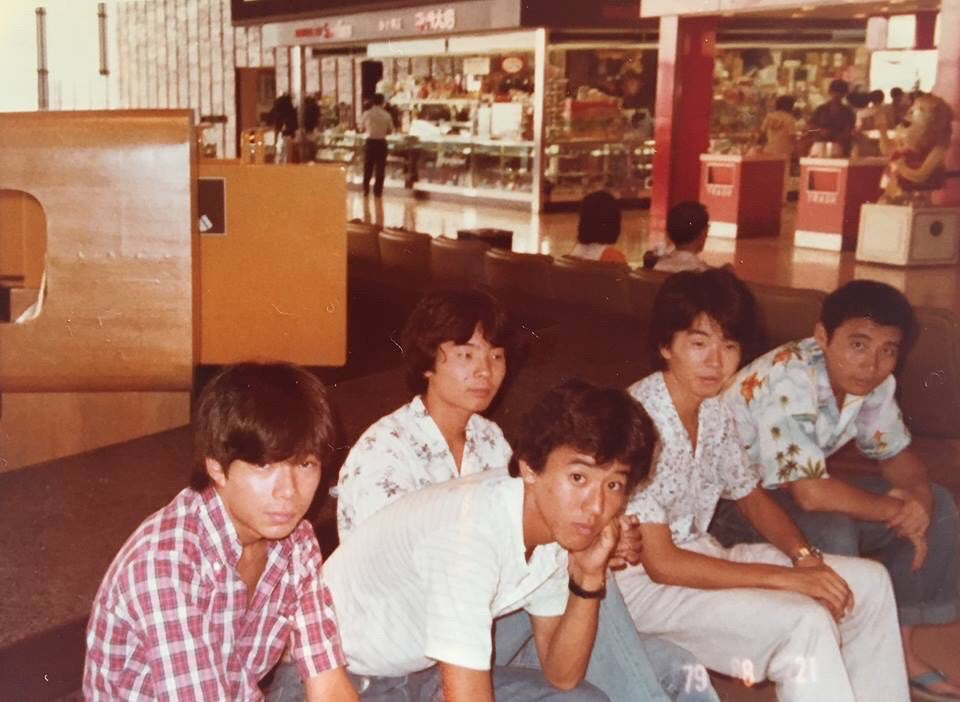 With high school classmates. The fashion also reflects the era, and it is interesting to note that everyone is wearing shirts.