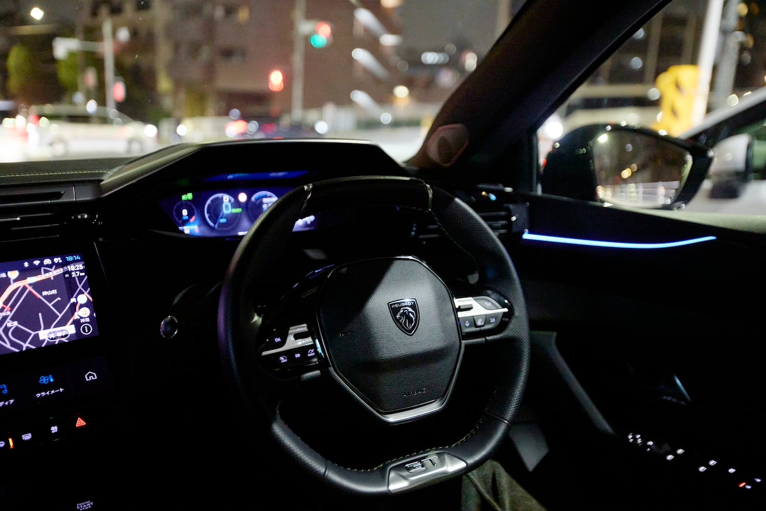 The driver's seat consists of a small diameter steering wheel, a head-up instrument panel, and a 10-inch touch screen.