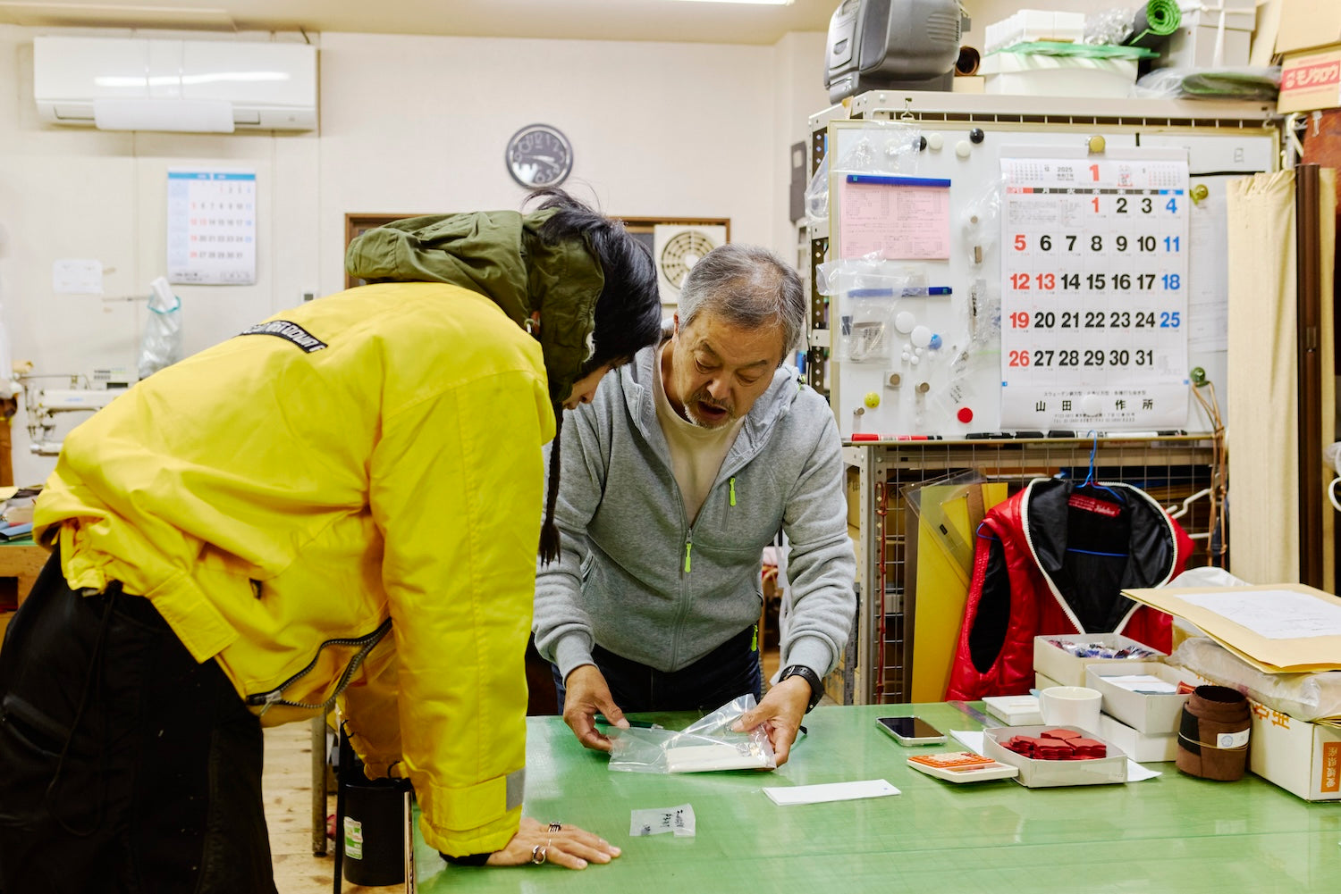 Tokio-san checks the finished product of the item he ordered. He has the look of a professional.