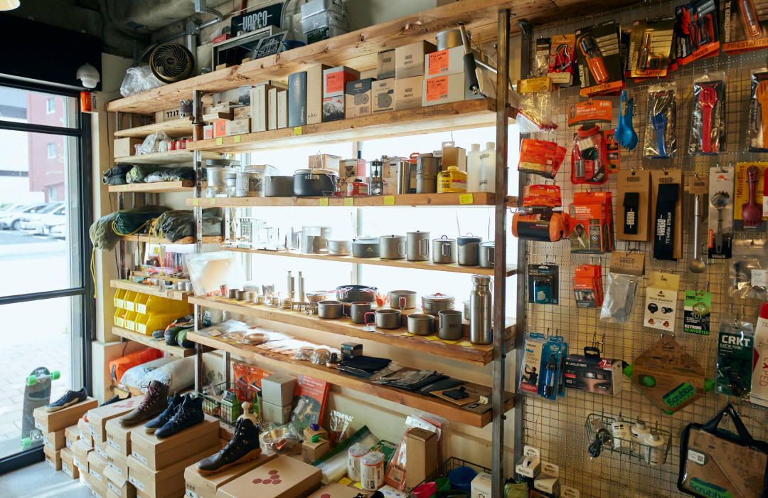 Cooking utensils and other items are displayed on the handmade wooden furniture. There is also a wide selection of emergency supplies.